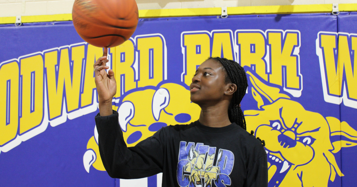 student balancing basketball on finger